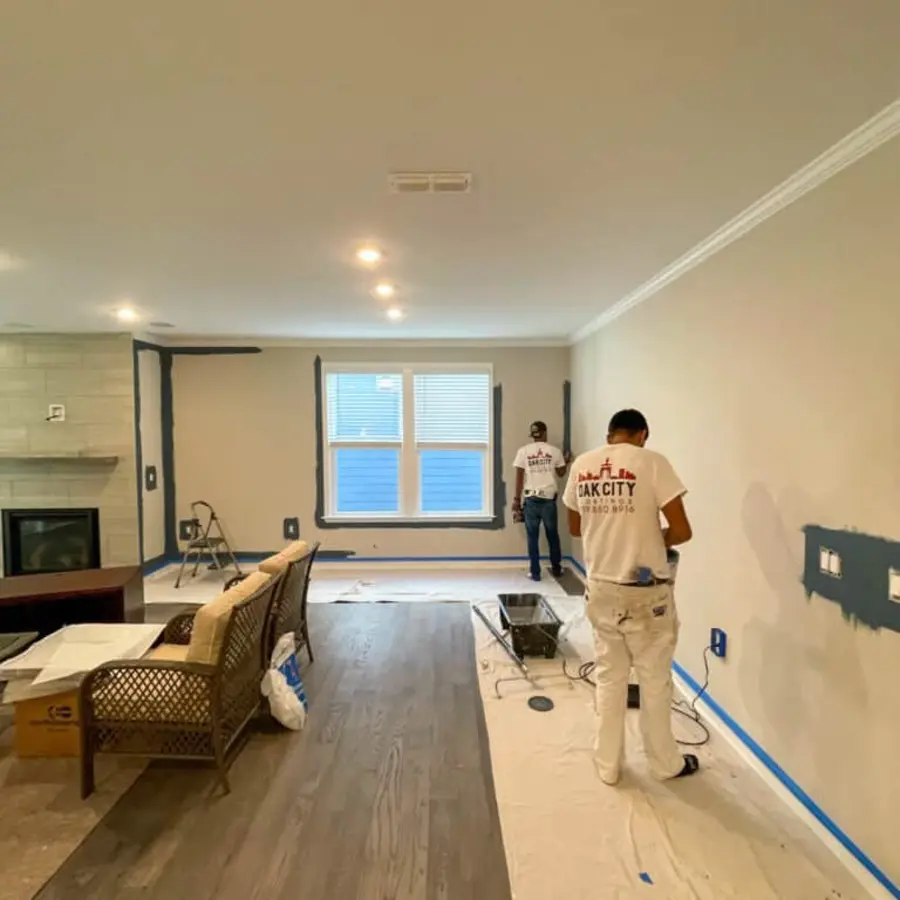 Professional painters working with full floor and furniture protection in place